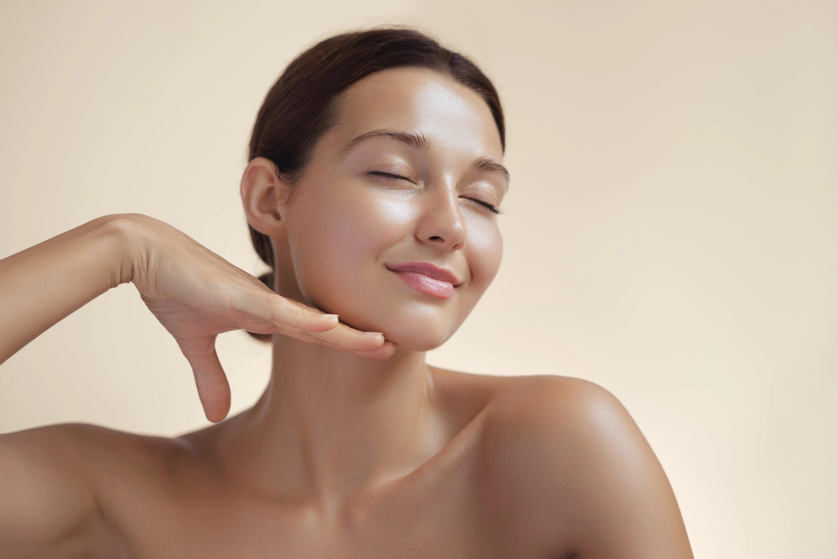 Woman with her skin glowing after treatment from Atlier Aesthetics